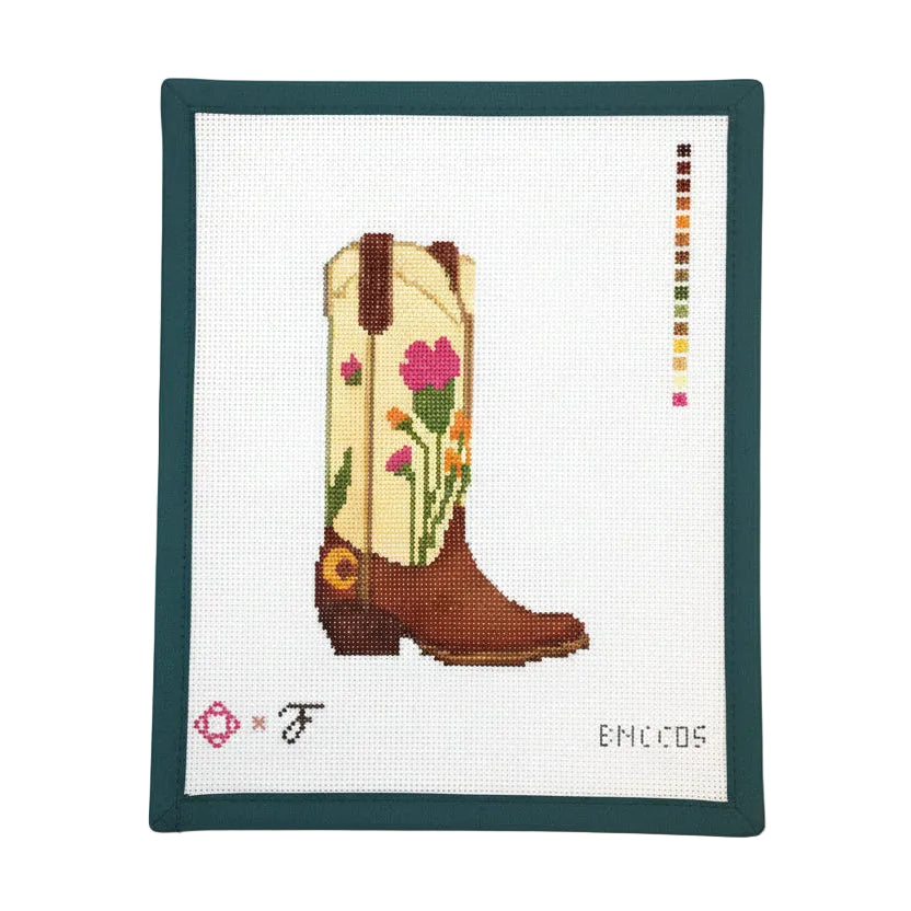 Cross-stitched cowboy boot with floral patterns on a white background